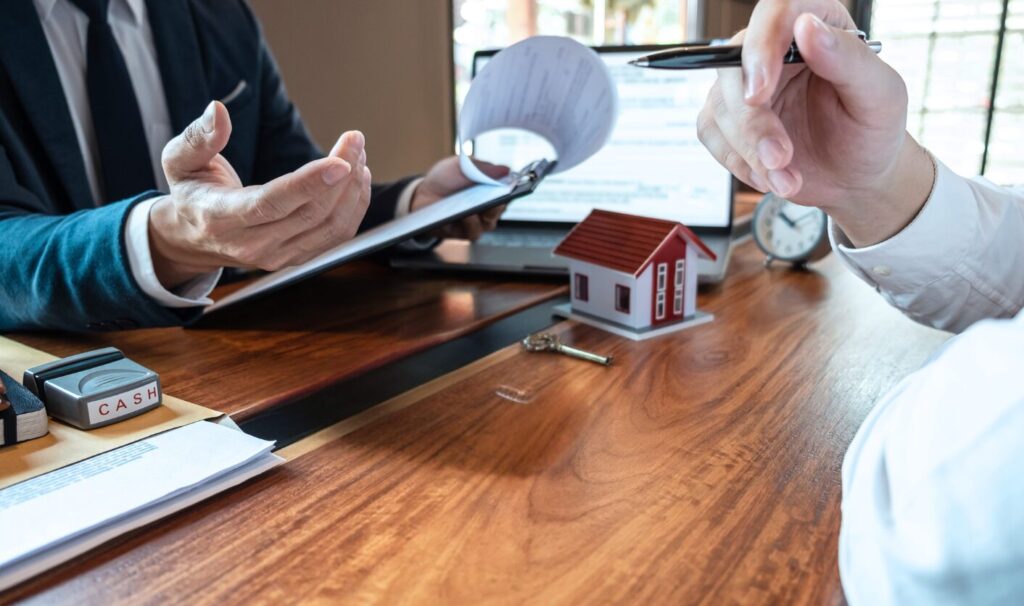 Estate agent reviewing property details with seller