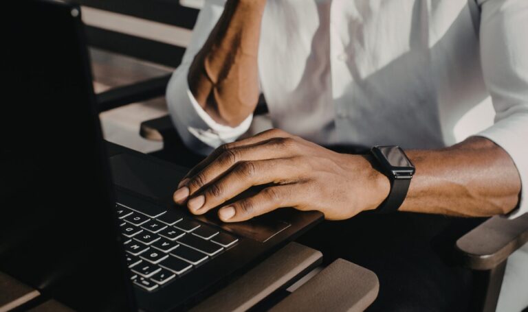 Landlord reviewing tenant affordability on laptop in home office