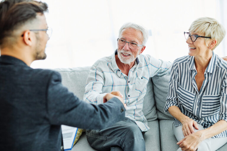 landlord shaking hands with tenants after discussing tenancy agreement and rent terms