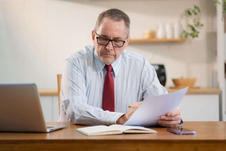 Landlord reviewing complaint documents at a desk, representing structured complaint handling and dispute resolution in property management
